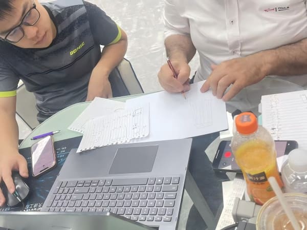Engineers discussing technical drawings